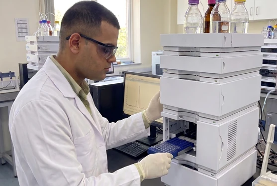 Scientist pipetting a sample during analytical testing