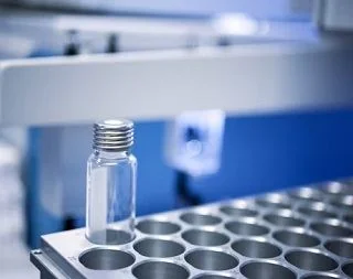 Glass sample vial on an automated lab instrument tray